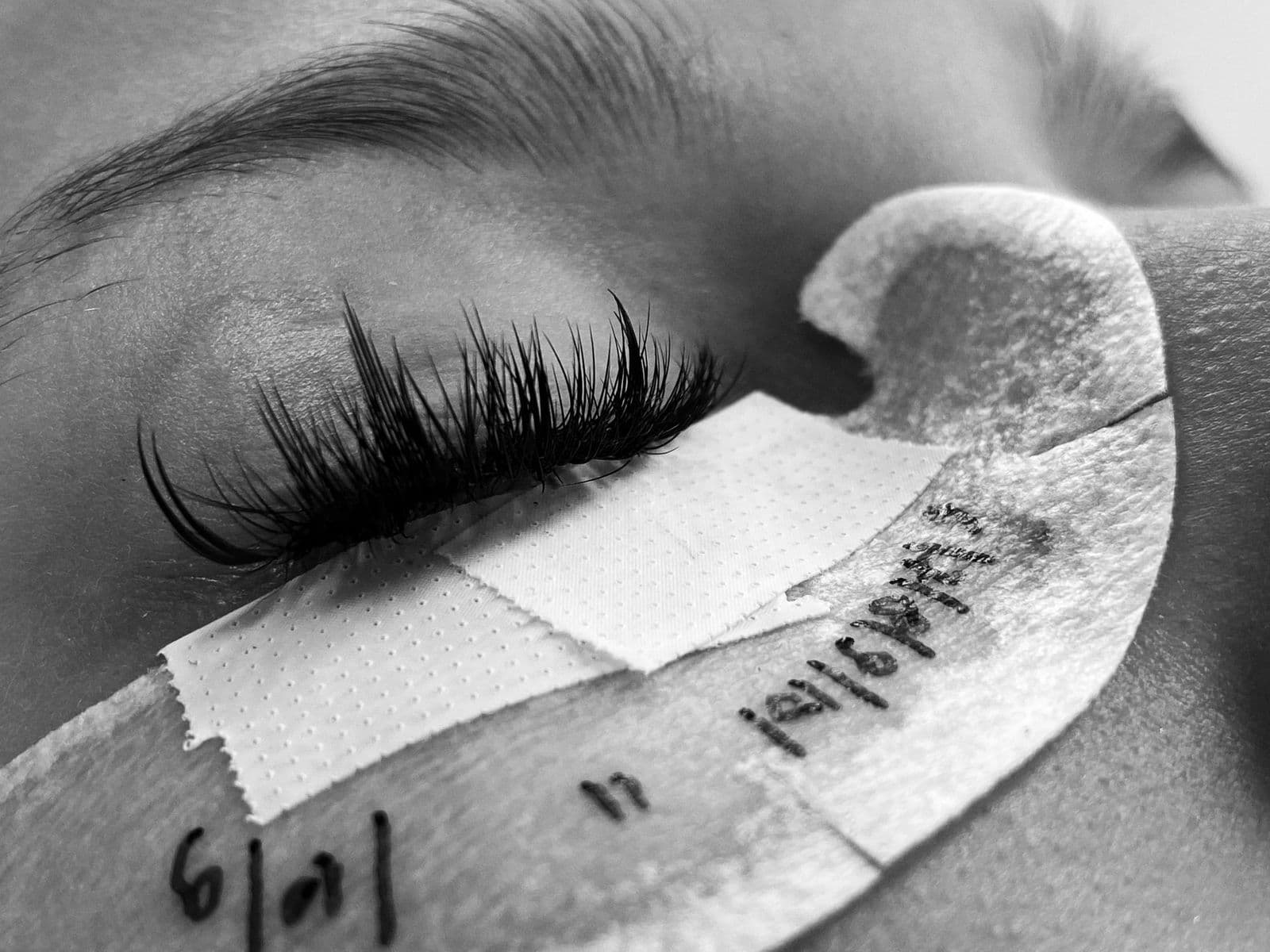 Lash application in progress under precise light.